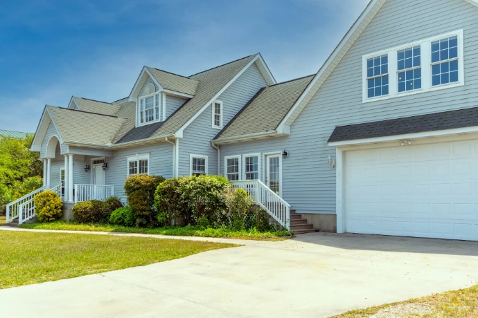 a white house with a large driveway in front of it